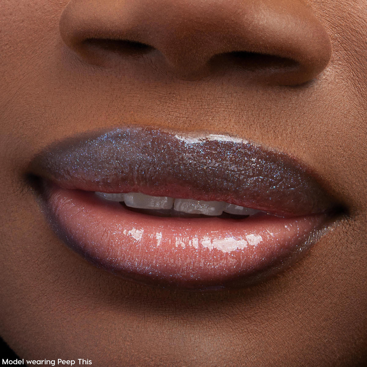 Glossy lips catch the light, wearing ColourPop Ultra Glossy Lip Squad Dreams; the sheer neutral lip gloss delivers a glassy, high-shine finish with fine silver shimmer, shown in an extreme close-up of a model’s mouth and lower nose.