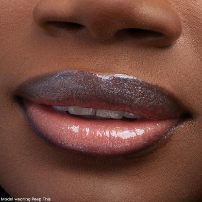 Glossy lips catch the light, wearing ColourPop Ultra Glossy Lip Squad Dreams; the sheer neutral lip gloss delivers a glassy, high-shine finish with fine silver shimmer, shown in an extreme close-up of a model’s mouth and lower nose.