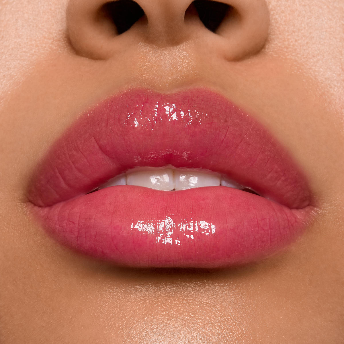 Glossy lips wearing ColourPop Ultra Glossy Lip in Surfer Vibes, delivering a sheer rosy pink tint with a high-shine, glassy finish in a tight studio close-up that highlights even coverage and reflective shine.