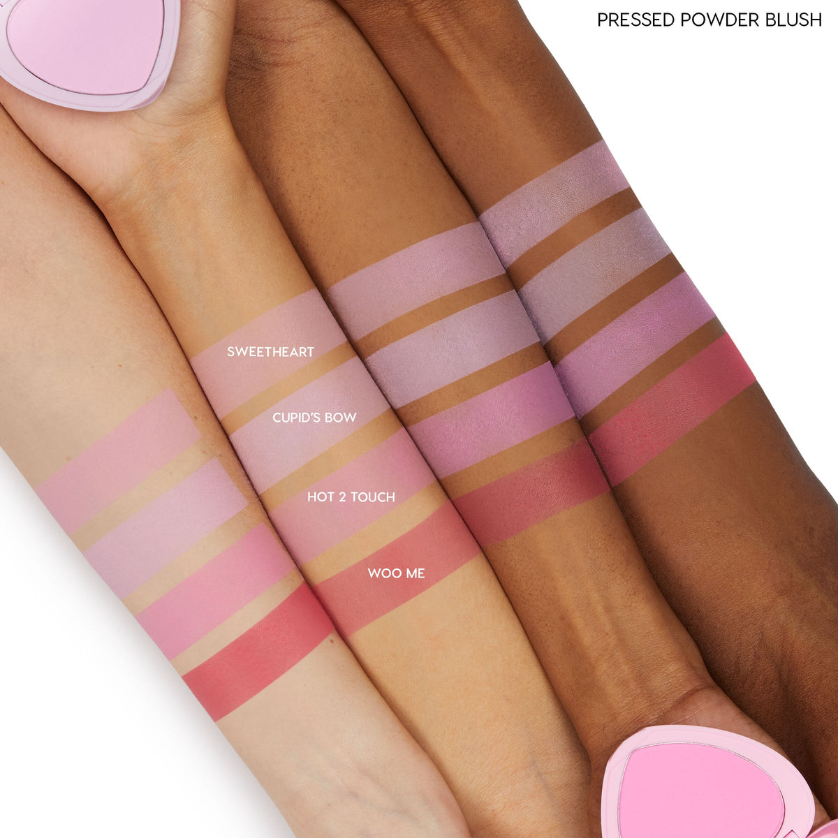 ColourPop Pressed Powder Blush, Cupid’s Bow, swatched in horizontal bands on three skin tones, a cool pink shade shown beside Sweetheart, Hot 2 Touch, and Woo Me, with a pink heart-shaped compact at the edges.