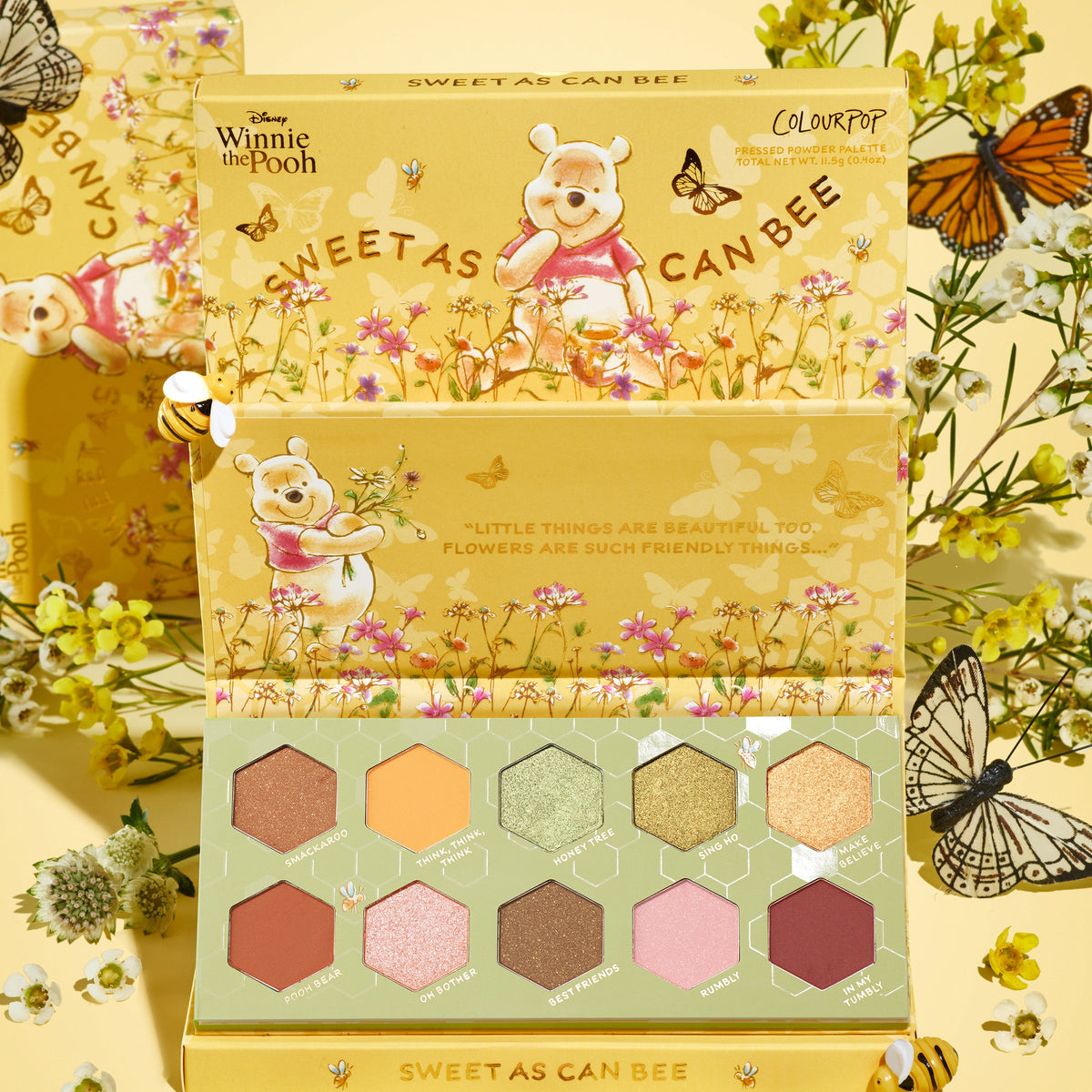 Sweet As Can Bee ColourPop Shadow Palette opens to reveal 10 hexagon pans of warm honey-toned mattes and shimmers, showcased in yellow packaging with Winnie the Pooh floral art, bees, and butterflies on a spring-themed backdrop.