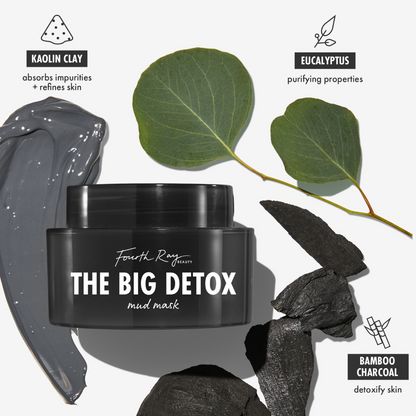 Black jar of Fourth Ray Beauty The Big Detox Mud Mask, a ColourPop Face Mask, centered with a glossy gray kaolin clay smear, eucalyptus leaves, and bamboo charcoal pieces, highlighting purifying, pore‑refining detox treatment for facial skin.