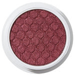 ColourPop Drift Super Shock Shadow displays a metallic cranberry-burgundy shimmer, pressed with a quilted scale pattern, sitting in a round white pot on a plain white studio background.