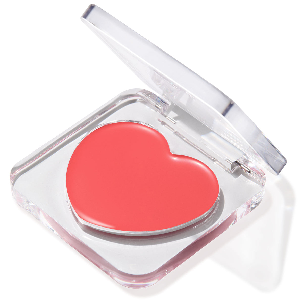 It’s a Look lip and cheek balm displayed in a half-open clear compact, revealing a heart-shaped coral pan; a creamy, buildable ColourPop Lip and Cheek Balm for multi-use tint on lips and cheeks, shown on a clean white backdrop.