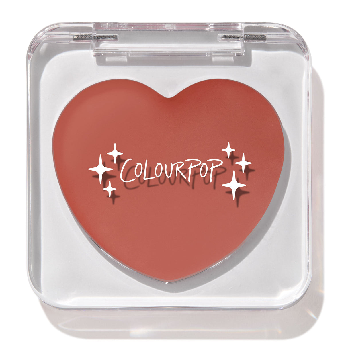 Heart-shaped ColourPop Lip and Cheek Balm in Larchmont Village sits closed in a clear square compact with sparkles logo, showcasing a warm terracotta hue on a bright white background.