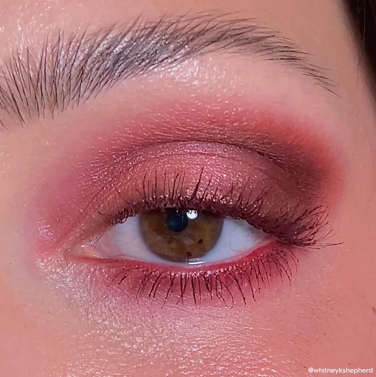 Shimmer wine-toned eyeshadow shades from ColourPop Wine and Only shadow palette blend across a brown eye, with cranberry shimmer on the lid, matte burgundy smoked on the outer corner and lower lash line, close-up makeup look.